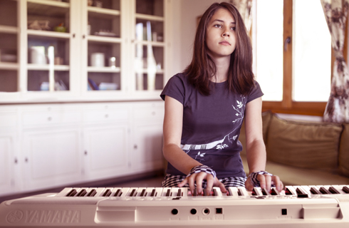 a person sitting on a piano